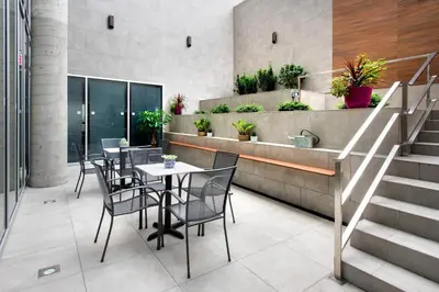a restaurant with a table and chairs and stairs at TownePlace Suites by Marriott New York Long Island City in Queens