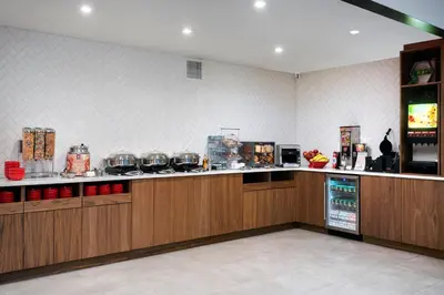 a kitchen with wooden cabinets and a counter top at TownePlace Suites by Marriott New York Long Island City in Queens