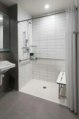 a bathroom with a shower and a sink at TownePlace Suites by Marriott New York Long Island City in Queens