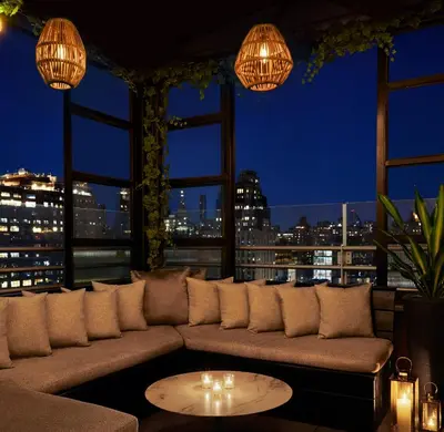 a living room with a couch and a view of the city at Gansevoort Meatpacking in New York