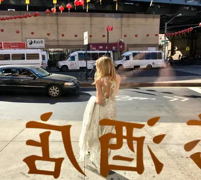 a woman in a wedding dress standing on a street at Hotel Mimosa in New York