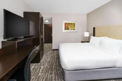 a hotel room with a bed and a flat screen tv at Fairfield Inn & Suites by Marriott New York Midtown Manhattan/Penn Station in New York