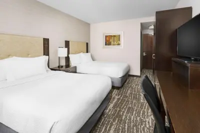a hotel room with two beds and a flat screen tv at Fairfield Inn & Suites by Marriott New York Midtown Manhattan/Penn Station in New York