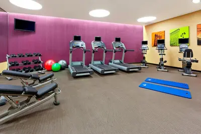 a gym with several treadmills and cardio machines at Fairfield Inn & Suites by Marriott New York Midtown Manhattan/Penn Station in New York