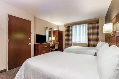 a hotel room with two beds and a television at Hampton Inn Manhattan Grand Central in New York