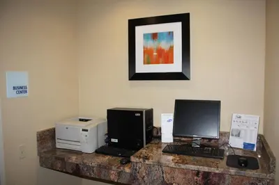 a desk with two computers and a printer at Holiday Inn Express - Ludlow - Chicopee Area by IHG in Ludlow