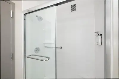 a shower with a glass door in a bathroom at Holiday Inn Express - Ludlow - Chicopee Area by IHG in Ludlow