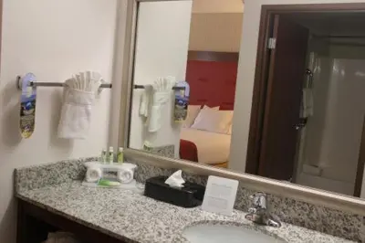 a bathroom with a sink and a mirror at Holiday Inn Express Milford by IHG in Milford