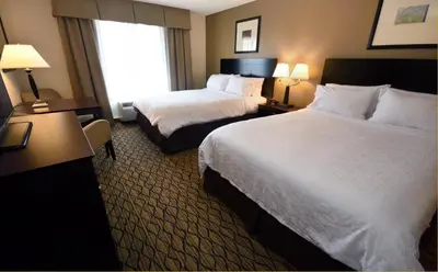 a hotel room with two beds and a window at Holiday Inn Express Milford by IHG in Milford