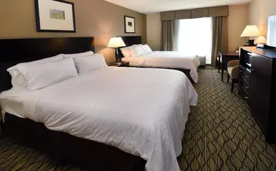 a hotel room with two beds and a window at Holiday Inn Express Milford by IHG in Milford