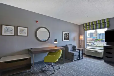 a hotel room with a desk and a chair at Hampton Inn & Suites Newark-Harrison-Riverwalk in Newark