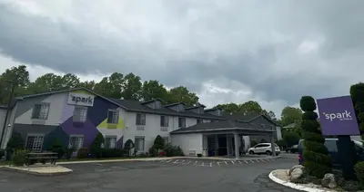a building with a parking lot in front of it at Spark by Hilton Guilford in Guilford