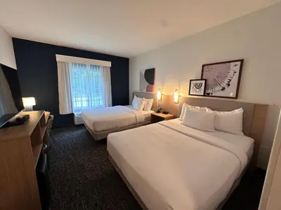 a hotel room with two beds and a window at Spark by Hilton Guilford in Guilford