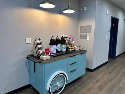 a counter with a blue cart with products on it at Spark by Hilton Guilford in Guilford