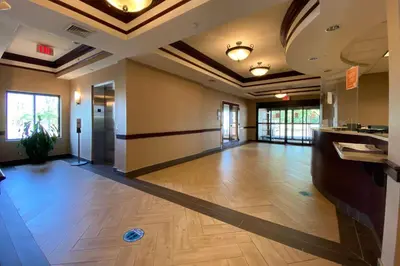 an empty lobby with a hard wood floor and windows at Comfort Inn East Windsor - Springfield in East Windsor