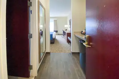 a room with a red door and a bedroom at Comfort Inn East Windsor - Springfield in East Windsor