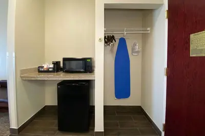 a room with a kitchen with a microwave and a refrigerator at Comfort Inn East Windsor - Springfield in East Windsor