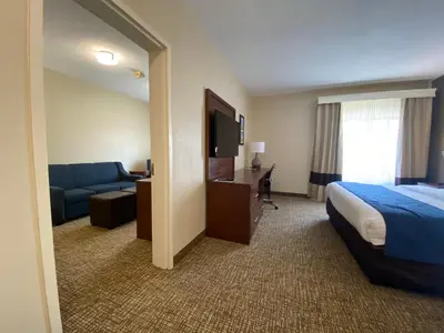 a hotel room with a bed and a couch at Comfort Inn East Windsor - Springfield in East Windsor