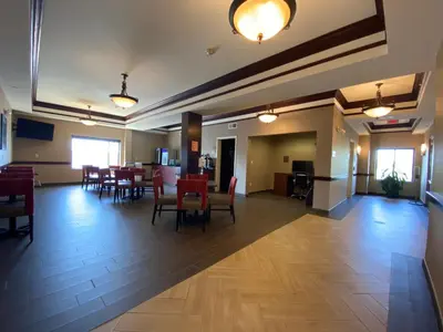 a dining room with a table and chairs in a building at Comfort Inn East Windsor - Springfield in East Windsor