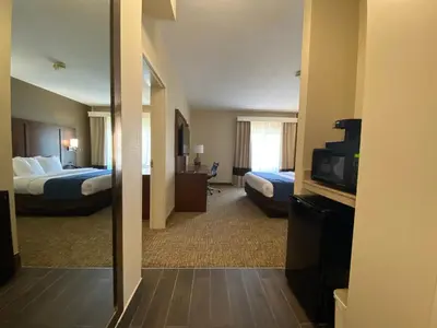a hotel room with two beds and a television at Comfort Inn East Windsor - Springfield in East Windsor