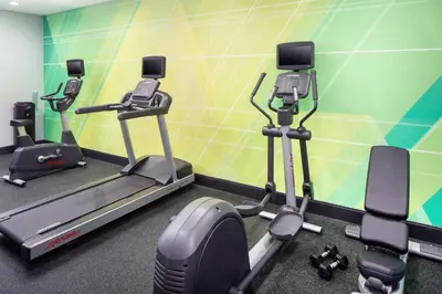 a gym with treadmills and elliptical machines at Holiday Inn Cheshire - Southington by IHG in Southington