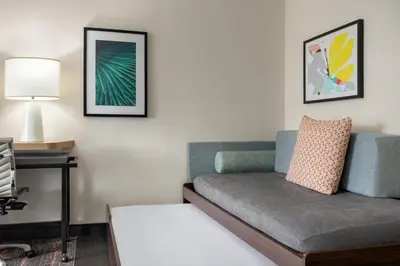 a living room with a couch and a lamp at Holiday Inn Cheshire - Southington by IHG in Southington