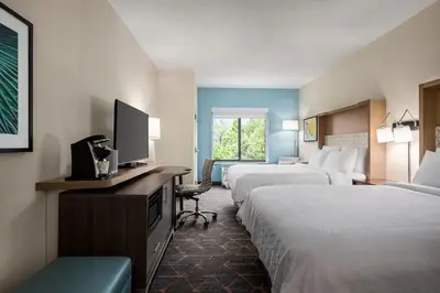 a hotel room with two beds and a flat screen tv at Holiday Inn Cheshire - Southington by IHG in Southington