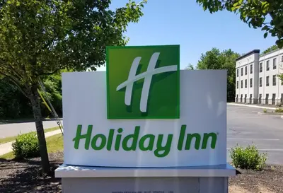 a sign for a holiday inn in front of a building at Holiday Inn Cheshire - Southington by IHG in Southington