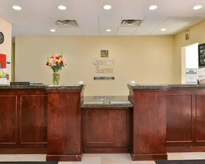 a lobby with a waiting area with a vase of flowers at Quality Suites Stratford in Stratford