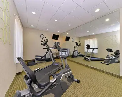 a gym with several exercise bikes in a room at Quality Suites Stratford in Stratford