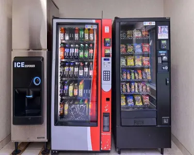 two soda vending machines are next to each other at Quality Suites Stratford in Stratford