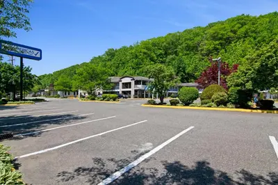 an empty parking lot in front of a mountain at Americas Best Value Inn Torrington, CT in Torrington