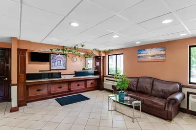a living room with a couch and a table at Americas Best Value Inn Torrington, CT in Torrington
