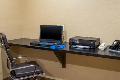 a desk with a laptop computer and a printer on it at Comfort Inn Naugatuck-Shelton, CT in Naugatuck