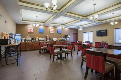a dining room with tables and chairs in a restaurant at Comfort Inn Naugatuck-Shelton, CT in Naugatuck