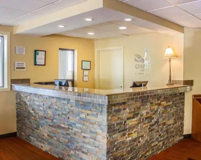 a lobby of a dental office with a stone counter at Quality Inn Waterbury East in Waterbury