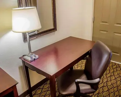 a desk with a chair and a lamp on it at Quality Inn Waterbury East in Waterbury