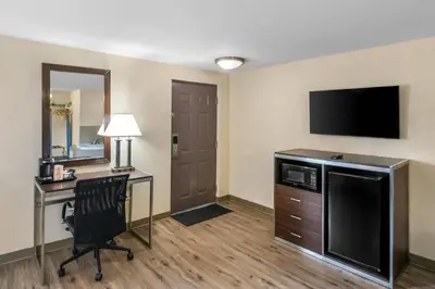 a hotel room with a desk and a television at Quality Inn Waterbury East in Waterbury