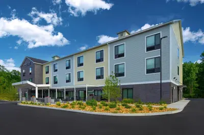 a large building in a parking lot at TownePlace Suites by Marriott Hadley Amherst in Hadley