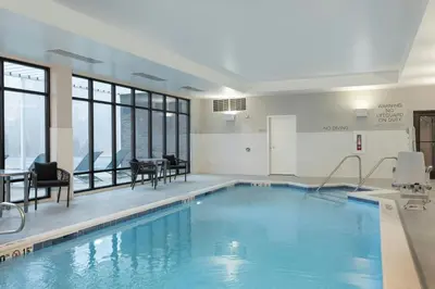 a large swimming pool with chairs and a table at TownePlace Suites by Marriott Hadley Amherst in Hadley