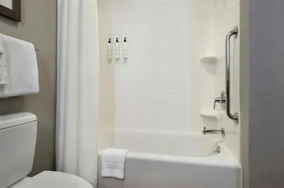 a bathroom with a white tub and a toilet at Fairfield Inn & Suites by Marriott Great Barrington Lenox/Berkshires in Great Barrington