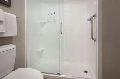 a bathroom with a shower with a glass door at Fairfield Inn & Suites by Marriott Great Barrington Lenox/Berkshires in Great Barrington