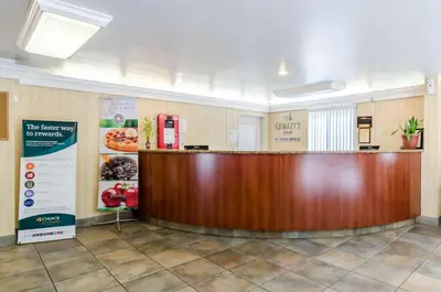 a lobby with a large wooden counter in a building at Quality Inn Chicopee-Springfield in Chicopee