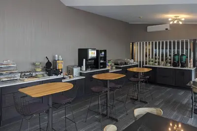 a restaurant with two tables and bar stools at Quality Inn & Suites Northampton - Amherst in Northampton