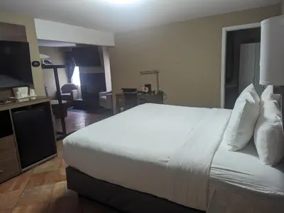 a hotel room with a bed and a television at Quality Inn & Suites Northampton - Amherst in Northampton