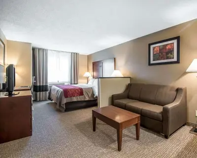 a hotel room with a bed and a couch at Comfort Inn Saugerties in Saugerties