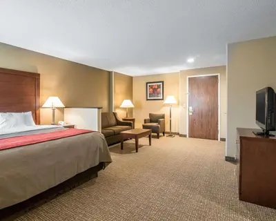 a hotel room with a bed and a flat screen tv at Comfort Inn Saugerties in Saugerties
