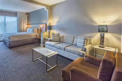 a hotel room with a couch and a bed at DoubleTree by Hilton Nanuet in Nanuet
