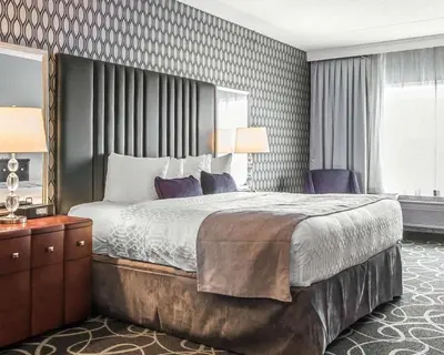 a hotel room with a large bed and a window at Park Manor Hotel in Clifton Park