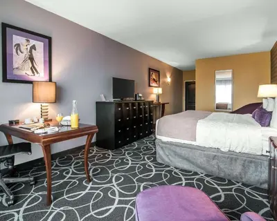 a hotel room with a bed and a desk at Park Manor Hotel in Clifton Park